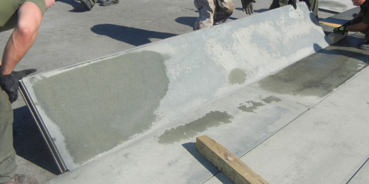Marines from Marine Corps Air Station, Expeditionary Airfields, Marine Wing Support Squadron 274 put down AM-2 matting on the Delta taxiway at Quantico’s Marine Corps Air Facility. ITAMCO will be replacing the labor-intensive AM-2 matting with a revolutionary product. (Photo by John Holli)